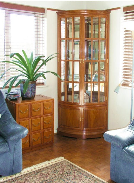 Rosewood corner cabinet with bow front.