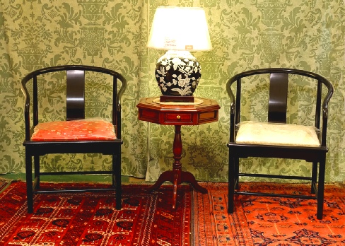 Octagonal rosewood side table with 2 drawers  Rosewood ocatgonal side table with 2 drawers, standing on a 3 legged pedestal, accompanying a pair of Chinese Ming style armchairs in ebonised rosewood.